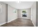 Simple, gray living room with wood floors and abundant natural light at 2524 Anastasia Dr, South Daytona, FL 32119