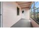 Covered porch with a painted floor, showing large windows and a closed entry door at 2524 Anastasia Dr, South Daytona, FL 32119