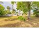 Large backyard with shed, mature trees, and well-maintained lawn creating a serene outdoor space at 2605 Fairmont Ave, New Smyrna Beach, FL 32168