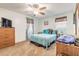 Cozy bedroom featuring a comfortable bed, ceiling fan, and ample natural light from the window at 2605 Fairmont Ave, New Smyrna Beach, FL 32168
