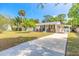 Charming single-story home with a well-manicured lawn, covered parking, and beautiful landscaping at 2605 Fairmont Ave, New Smyrna Beach, FL 32168