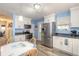 Kitchen features stainless steel appliances, white cabinetry, and a view into an adjacent office space at 2605 Fairmont Ave, New Smyrna Beach, FL 32168