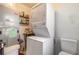 Stacked washer and dryer with a utility sink, and shelf storage above the laundry machines at 2605 Fairmont Ave, New Smyrna Beach, FL 32168