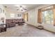 Cozy living room with plush seating, a ceiling fan, and natural light streaming through the windows at 2605 Fairmont Ave, New Smyrna Beach, FL 32168