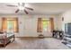 Bright and airy living room with two windows, neutral carpeting, and lots of natural light at 2605 Fairmont Ave, New Smyrna Beach, FL 32168