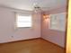 Cozy bedroom with warm colors, laminate floors, a window and built in shelves at 26225 Troon Ave, Mount Plymouth, FL 32776
