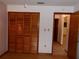 Bright bedroom with wood laminate floors and closet with bi-fold doors at 26225 Troon Ave, Mount Plymouth, FL 32776