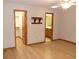 Bedroom featuring wood laminate floors, closet, and view to the bathroom at 26225 Troon Ave, Mount Plymouth, FL 32776