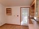 Bright dining room with laminate floors, built in shelves, and a back door at 26225 Troon Ave, Mount Plymouth, FL 32776
