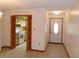 Entryway featuring tile floors, view to kitchen, bi-fold doors, and front door at 26225 Troon Ave, Mount Plymouth, FL 32776