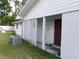 Backyard features lattice, a well-maintained lawn, and a covered back entrance at 26225 Troon Ave, Mount Plymouth, FL 32776