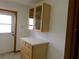 Hallway cabinet with glass insets, drawers, and counter space provides ample storage at 26225 Troon Ave, Mount Plymouth, FL 32776