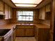 Cozy kitchen with light wood cabinets, tile floors, and stainless-steel appliances at 26225 Troon Ave, Mount Plymouth, FL 32776