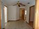 Spacious living room area with neutral paint and trim, with tile floors and a ceiling fan at 26225 Troon Ave, Mount Plymouth, FL 32776