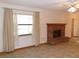 Cozy living room featuring tile flooring, large windows with curtains, and a brick fireplace at 26225 Troon Ave, Mount Plymouth, FL 32776