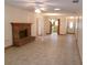 Living room with brick fireplace, ceiling fan, and tile floors at 26225 Troon Ave, Mount Plymouth, FL 32776