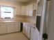 Bonus room or office area with ample cabinetry and counter space, with a window for natural light at 26225 Troon Ave, Mount Plymouth, FL 32776