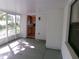 View of a kitchen through the doorway of a well-lit and screened porch at 26225 Troon Ave, Mount Plymouth, FL 32776