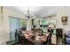 Open kitchen and dining area with a long wooden table with chairs for the Gathering at 2625 Sweet Springs St, Deltona, FL 32738