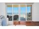 Ocean view from sliding glass doors leading to balcony, with seating and blue rug at 2855 S Atlantic Ave # 303, Daytona Beach Shores, FL 32118