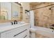 Updated bathroom with marble countertop, white vanity, and bathtub-shower combo at 2855 S Atlantic Ave # 303, Daytona Beach Shores, FL 32118