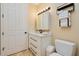 Well-lit bathroom featuring vanity with storage, light fixture, and a toilet at 2855 S Atlantic Ave # 303, Daytona Beach Shores, FL 32118