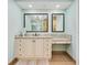 Modern bathroom with granite counters, dual vanity, and well-lit mirrors at 2855 S Atlantic Ave # 303, Daytona Beach Shores, FL 32118