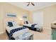 Comfortable bedroom with two beds, complemented by beachy decor, and ample closet space at 2855 S Atlantic Ave # 303, Daytona Beach Shores, FL 32118