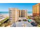 Beautiful condo building exterior with tan siding, ocean view, and outdoor pool at 2855 S Atlantic Ave # 303, Daytona Beach Shores, FL 32118