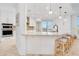 Bright, modern kitchen featuring stainless appliances, granite counters, breakfast bar seating, and modern pendant lighting at 2855 S Atlantic Ave # 303, Daytona Beach Shores, FL 32118