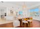 Bright open kitchen features modern appliances, stone counters and opens to a dining area with water views at 2855 S Atlantic Ave # 303, Daytona Beach Shores, FL 32118