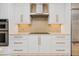 Close up of kitchen featuring stainless appliances, white custom cabinetry, granite counters, and tile backsplash at 2855 S Atlantic Ave # 303, Daytona Beach Shores, FL 32118