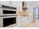 Close up of the kitchen featuring stainless appliances, white custom cabinets and drawers, and granite counters at 2855 S Atlantic Ave # 303, Daytona Beach Shores, FL 32118