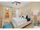 Comfortable main bedroom features a walk-in closet, large upholstered headboard, ceiling fan, and lots of natural light at 2855 S Atlantic Ave # 303, Daytona Beach Shores, FL 32118