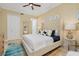 Comfortable main bedroom features a large upholstered headboard, ceiling fan, and lots of natural light at 2855 S Atlantic Ave # 303, Daytona Beach Shores, FL 32118