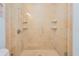 Modern shower with glass enclosure, tiled walls, and built-in shelves for added convenience at 2855 S Atlantic Ave # 303, Daytona Beach Shores, FL 32118