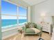 Cozy sitting area with an armchair, ocean view and stylish decor, perfect for relaxation at 2855 S Atlantic Ave # 303, Daytona Beach Shores, FL 32118