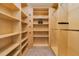 Spacious walk-in closet with custom wood shelving and ample storage, perfect for organizing clothes and accessories at 2855 S Atlantic Ave # 303, Daytona Beach Shores, FL 32118