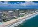 Panoramic aerial view showcases condo towers along the ocean, highlighting beach access and scenic coastal living opportunities at 2900 N Atlantic Ave # 2003, Daytona Beach, FL 32118