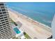 Aerial view from building showcasing pool and the beach with blue water and blue sky at 2900 N Atlantic Ave # 2003, Daytona Beach, FL 32118