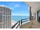 Balcony view of the beach featuring a patio set, with another building in the background at 2900 N Atlantic Ave # 2003, Daytona Beach, FL 32118