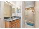 Bathroom featuring a vanity with a granite countertop, a large mirror, and glass-enclosed shower at 2900 N Atlantic Ave # 2003, Daytona Beach, FL 32118