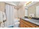 Bathroom featuring granite counters, wood cabinets, a tub/shower combo, and tile flooring at 2900 N Atlantic Ave # 2003, Daytona Beach, FL 32118