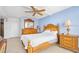 Inviting bedroom featuring a decorative ceiling fan, wooden furniture, and a relaxing ambiance at 2900 N Atlantic Ave # 2003, Daytona Beach, FL 32118