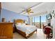 Comfortable bedroom with ceiling fan, balcony access, and serene decor at 2900 N Atlantic Ave # 2003, Daytona Beach, FL 32118