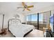 Bright bedroom featuring a ceiling fan, artwork, tile floors, and sliding glass doors to the balcony at 2900 N Atlantic Ave # 2003, Daytona Beach, FL 32118