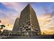 Exterior elevation shot of a tall beachfront building with multiple balconies at sunset at 2900 N Atlantic Ave # 2003, Daytona Beach, FL 32118