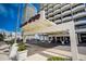 Beautiful Beach Club entrance with well-maintained landscaping and covered drop-off to welcome residents and guests at 2900 N Atlantic Ave # 2003, Daytona Beach, FL 32118