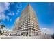 Exterior view of a high-rise building under a beautiful sky with palm trees at 2900 N Atlantic Ave # 2003, Daytona Beach, FL 32118