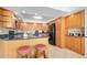 Well-maintained kitchen featuring wood cabinets, black appliances, and breakfast bar seating at 2900 N Atlantic Ave # 2003, Daytona Beach, FL 32118